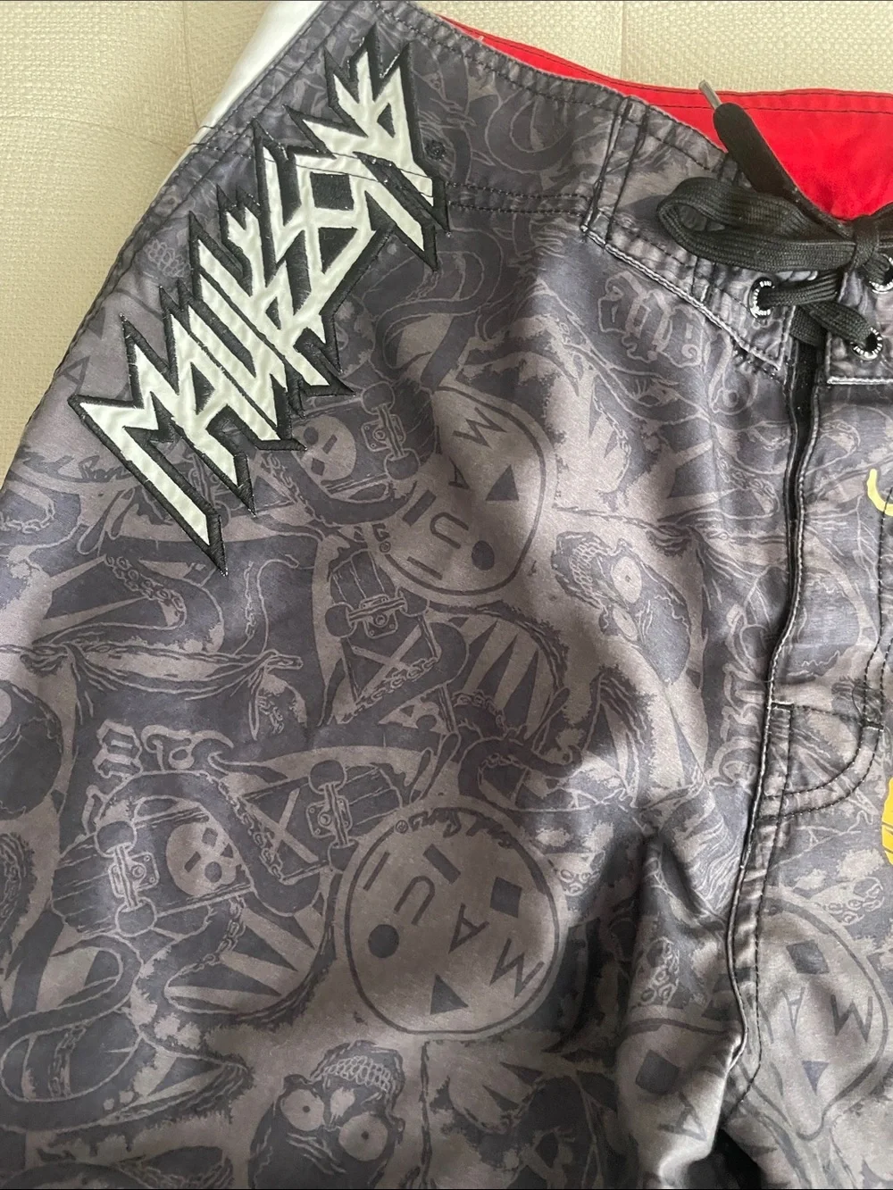 Maui and Sons Black Swim Shorts with Red & Yellow Skull Graphic